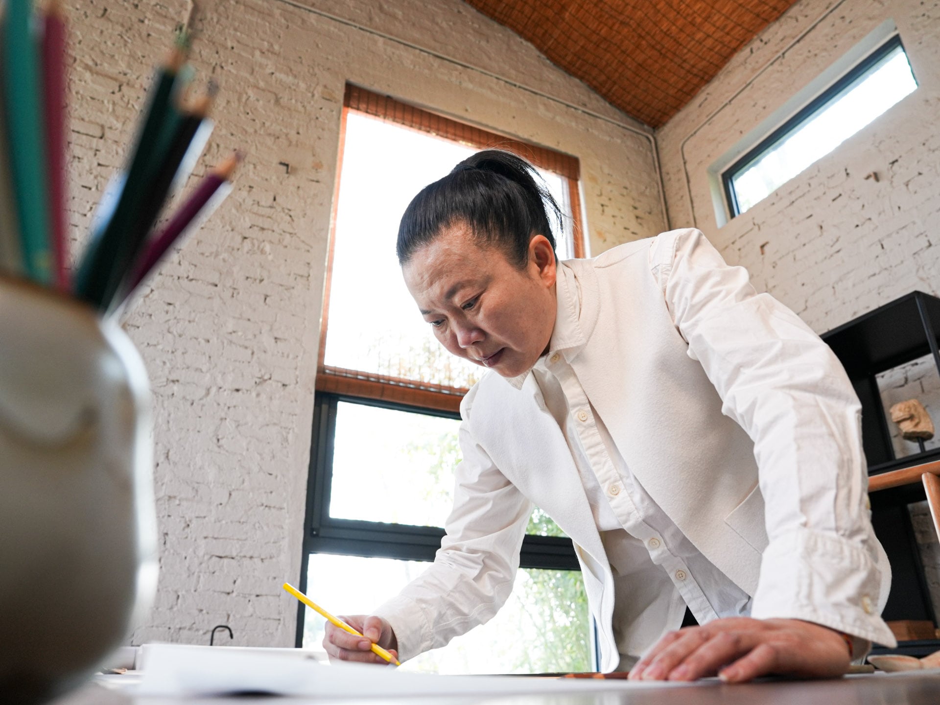 Wang Limin creating in her workshop